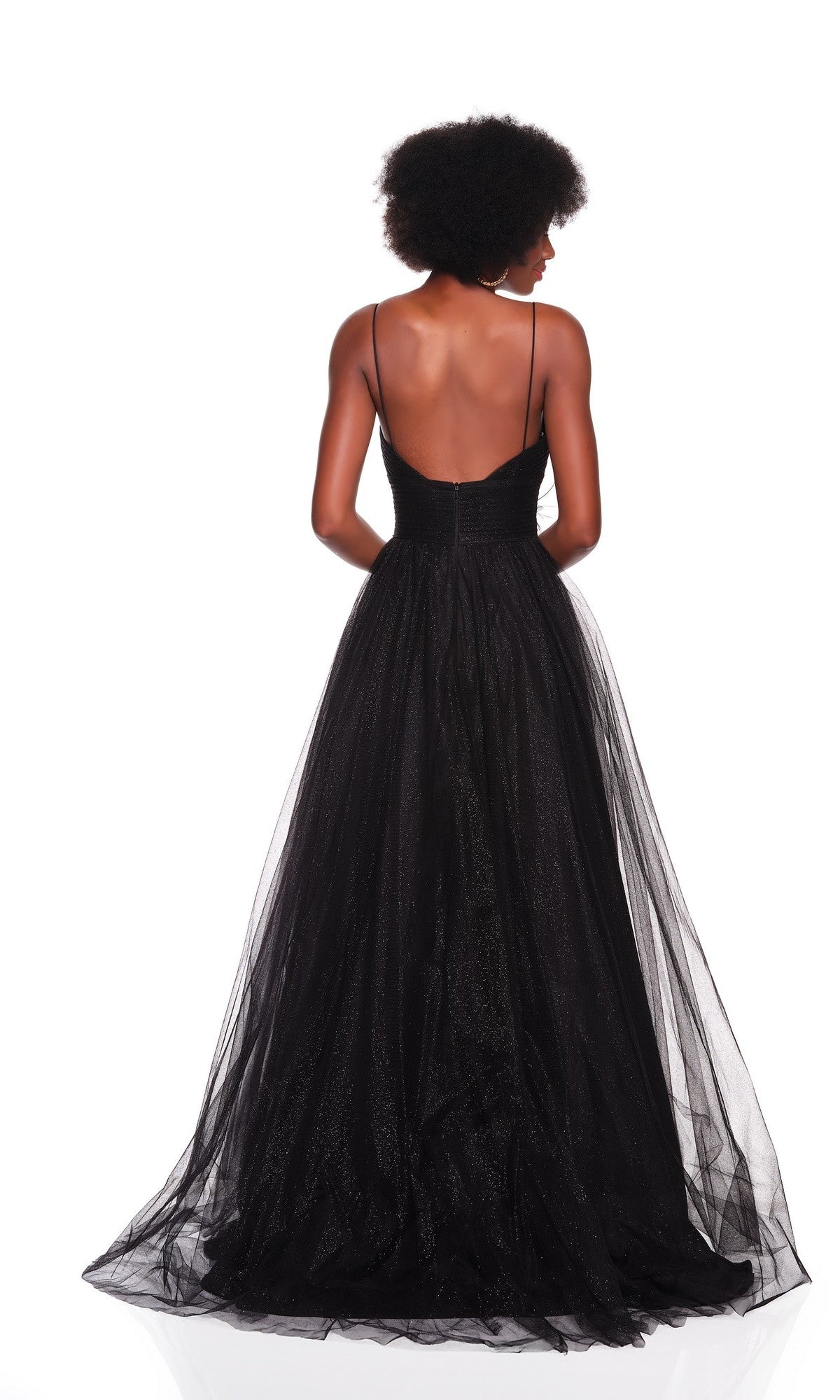 Woman wearing the Dave & Johnny 12380 Black Glitter Prom Ball Gown with thin straps and an open back, standing against a white background, facing away from the camera.